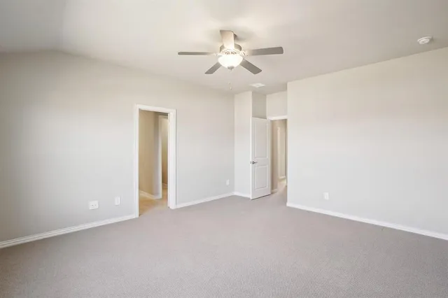 an empty room with fan and a ceiling fan