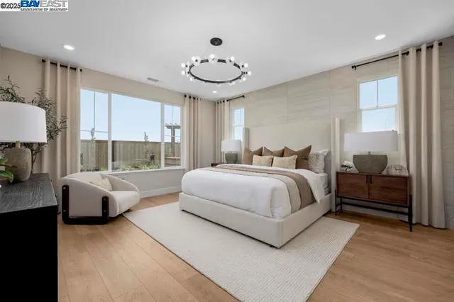 a spacious bedroom with a bed and a large window