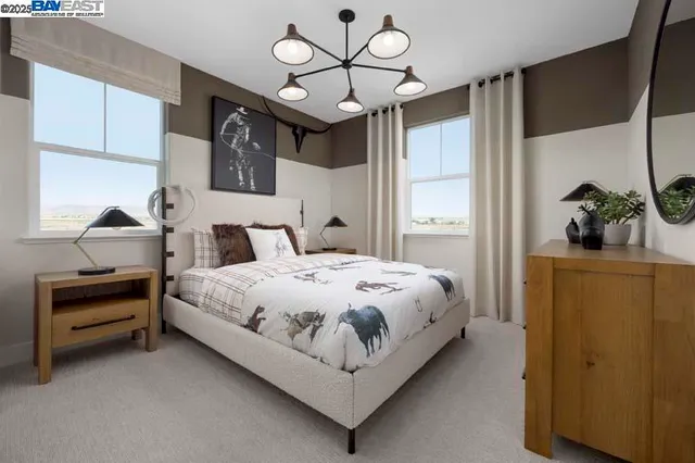 a bedroom with a bed and a chandelier