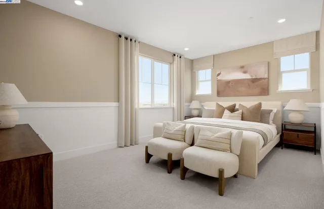 a spacious bedroom with a bed and a couch