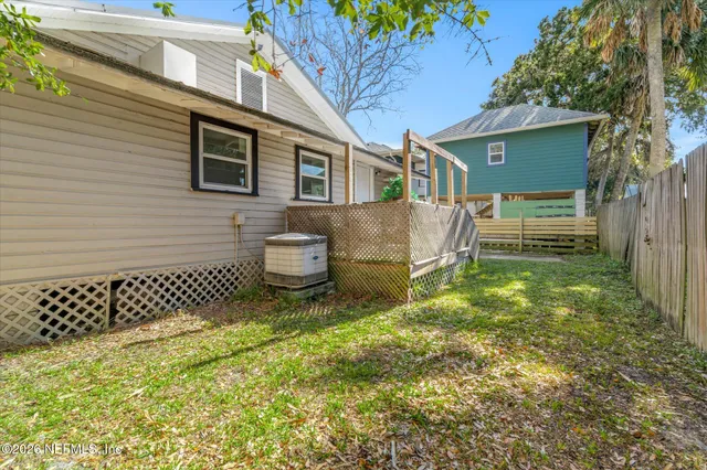 an aerial view of residential houses with outdoor space and lake view