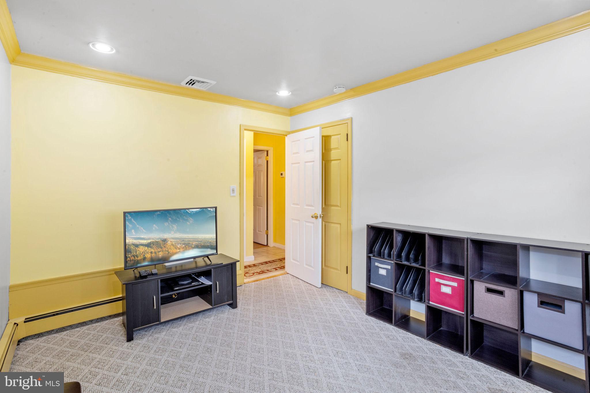 74 Gaping Rock Road Levittown, PA 19057 - Photo 17 of 31 a living room with furniture and a flat screen tv