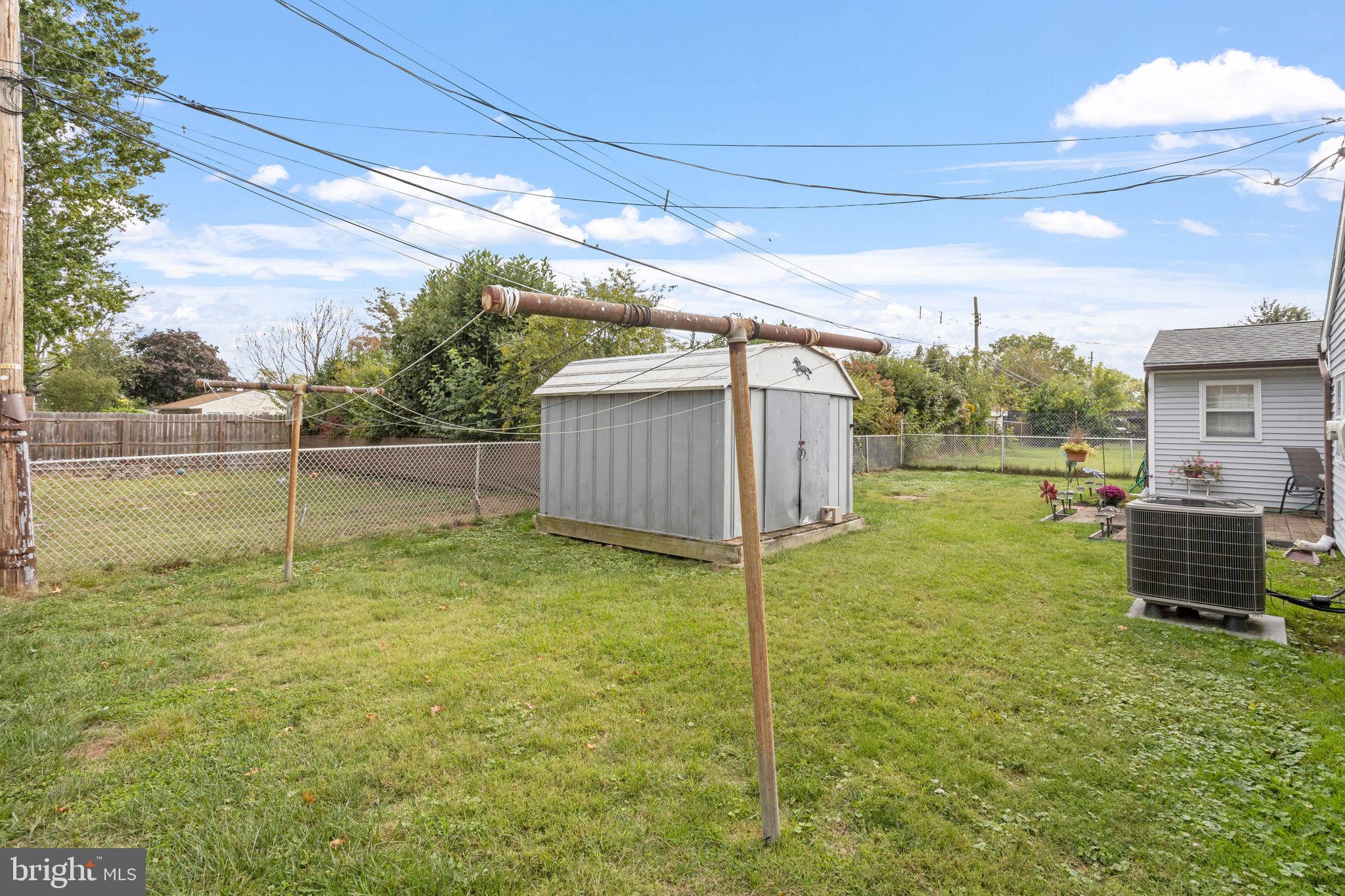 74 Gaping Rock Road Levittown, PA 19057 - Photo 27 of 31 a backyard of a house with a yard and garage