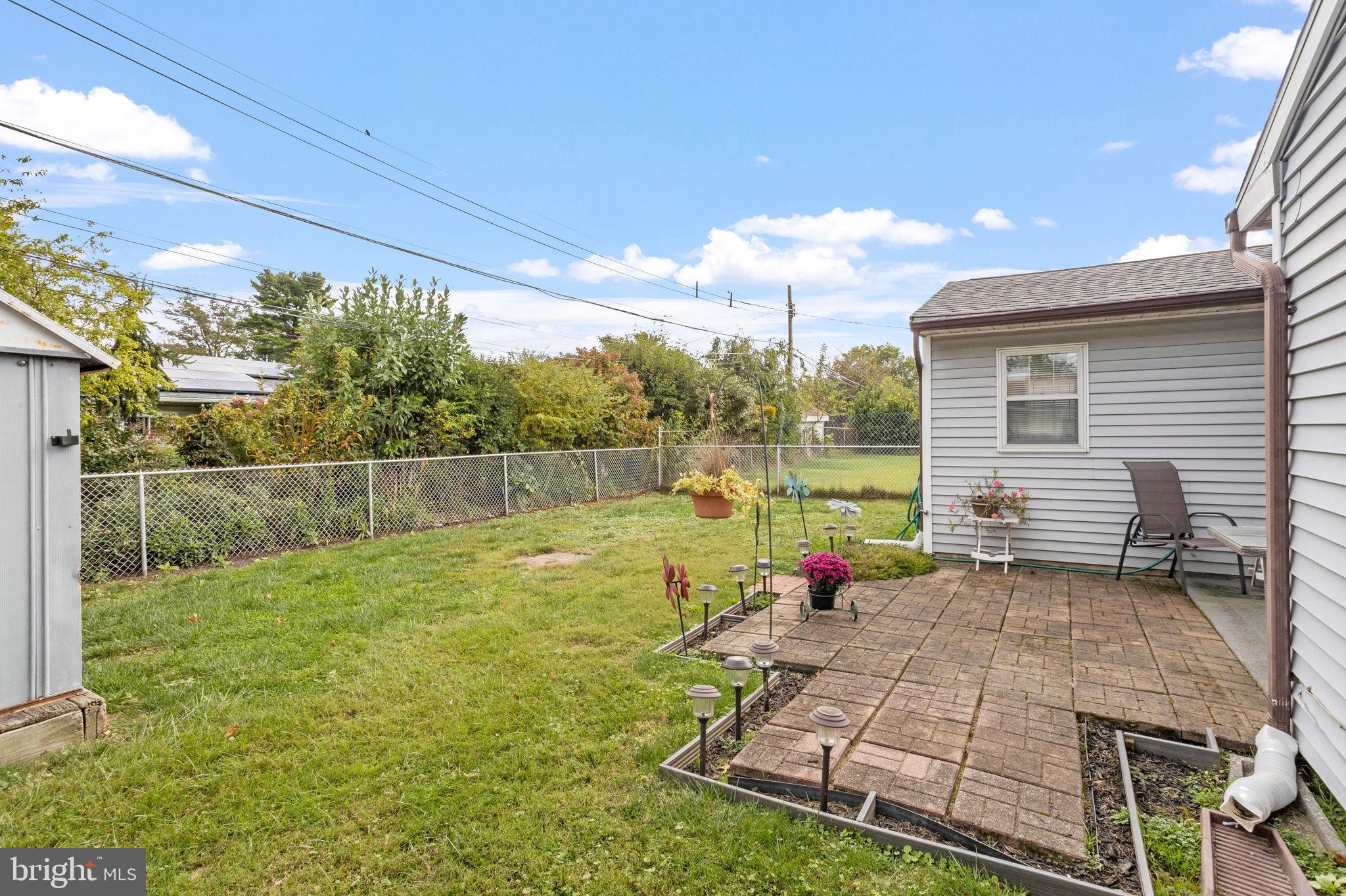 74 Gaping Rock Road Levittown, PA 19057 - Photo 28 of 31 a backyard of a house with table and chairs