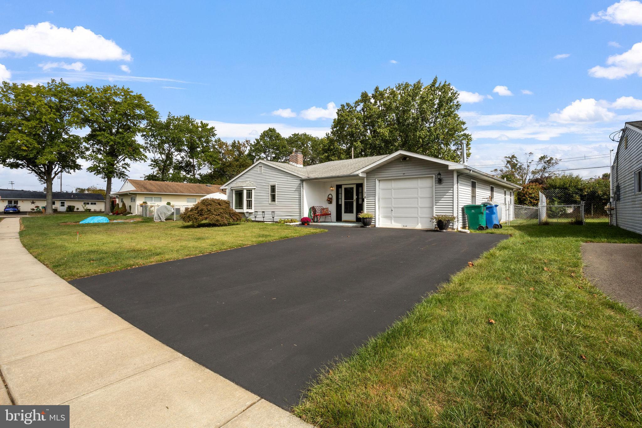 74 Gaping Rock Road Levittown, PA 19057 - Photo 31 of 31 a white house with a big yard and large trees