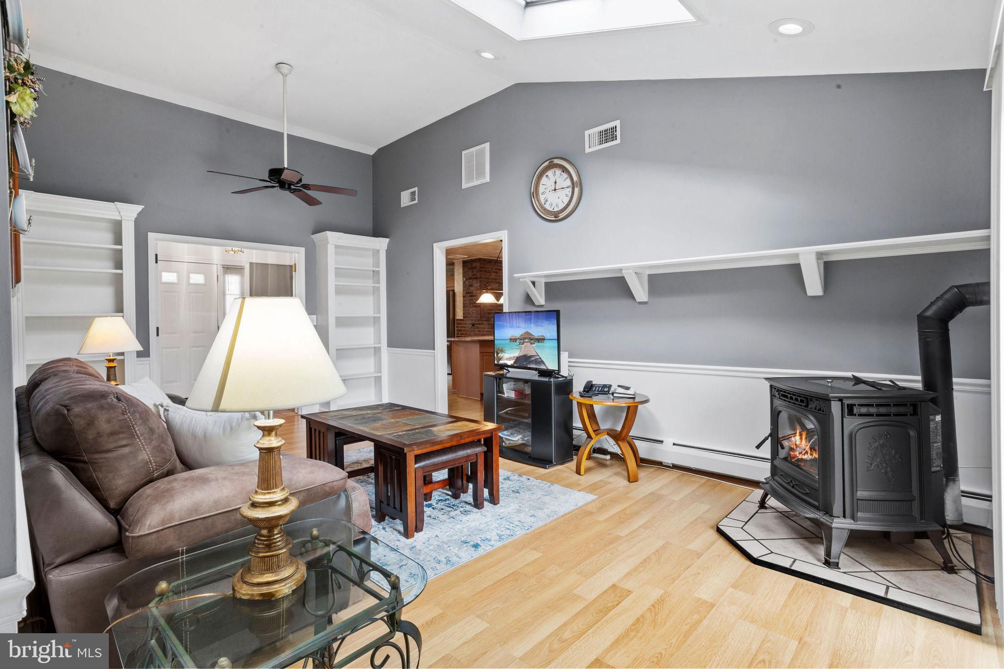 74 Gaping Rock Road Levittown, PA 19057 - Photo 6 of 31 a living room with furniture a flat screen tv and gym equipment