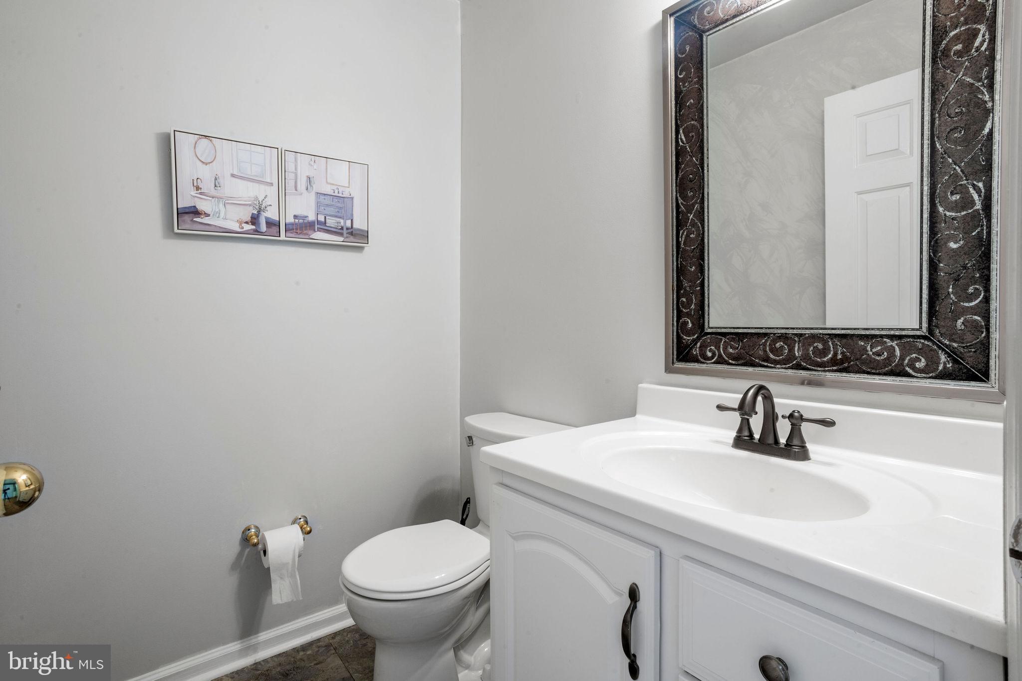 74 Gaping Rock Road Levittown, PA 19057 - Photo 7 of 31 a bathroom with a toilet sink and mirror