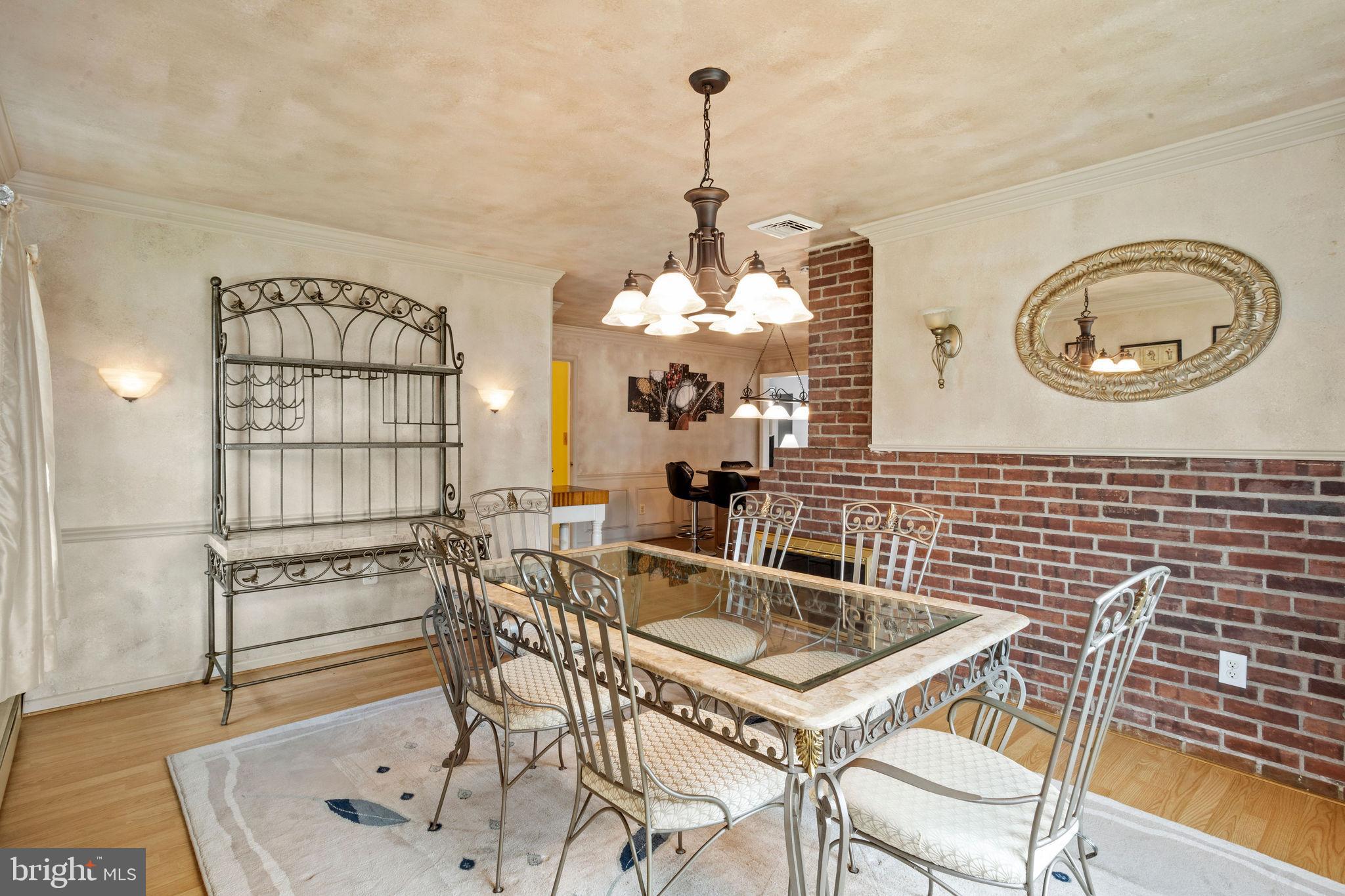 74 Gaping Rock Road Levittown, PA 19057 - Photo 9 of 31 a kitchen with a table chairs and a chandelier