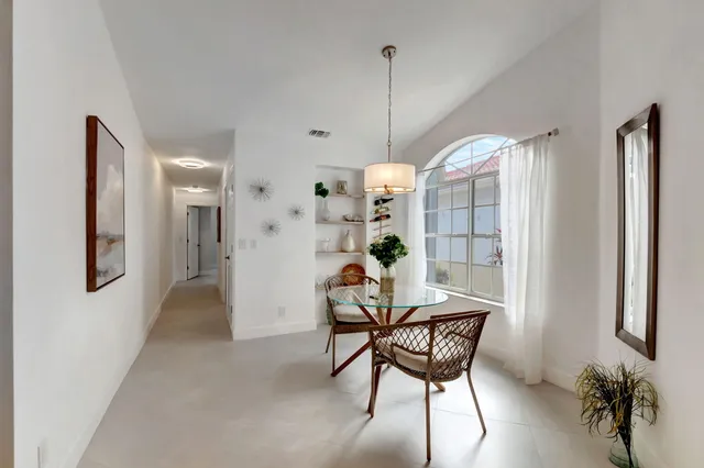 a view of a room with furniture and a chandelier