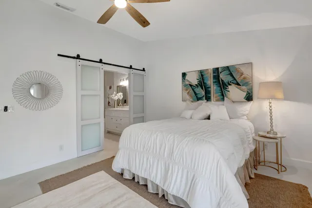 a bedroom with a bed and a painting on the wall