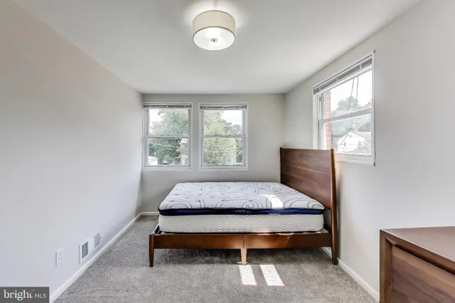 a bed sitting in a bedroom next to a window