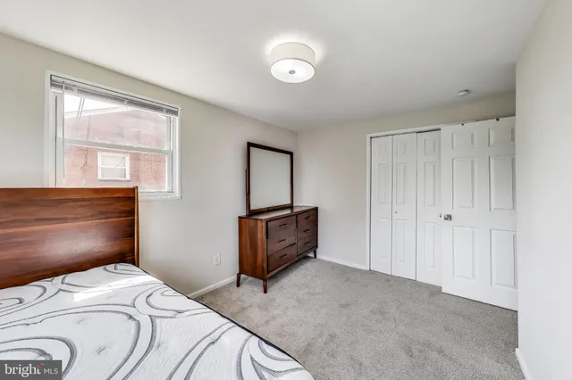 a bedroom with a bed and a dresser