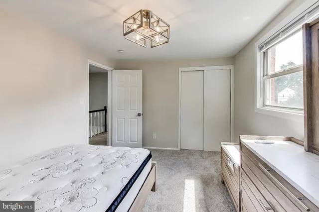 a bedroom with a bed and a window in it