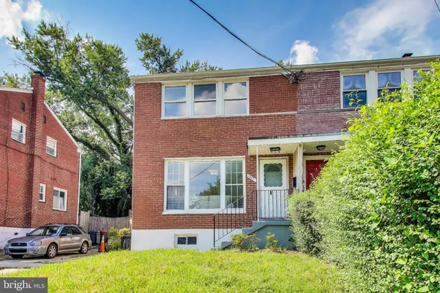 a front view of a house with yard and outdoor seating