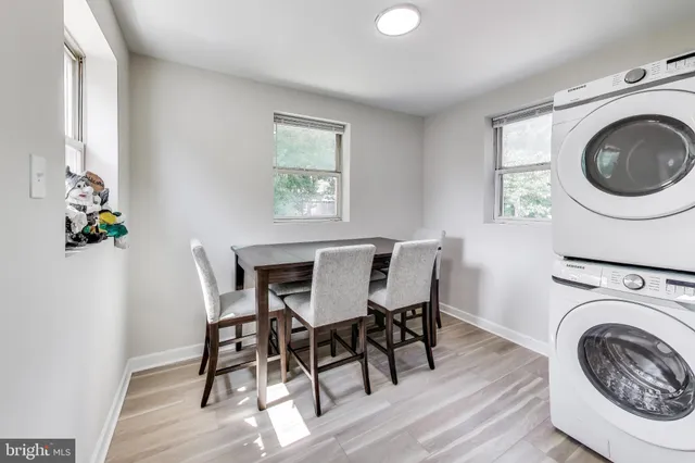 a view of a dining room with furniture and wooden floor