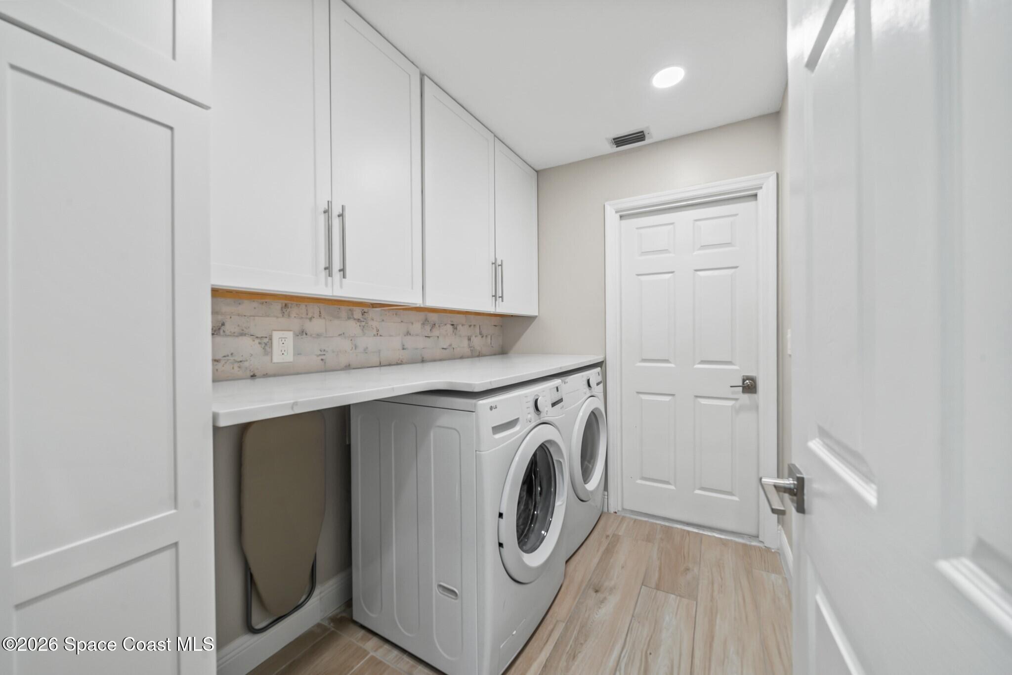 697 Spring Lake Drive Melbourne, FL 32940 - Photo 28 of 45 a utility room with dryer and washer