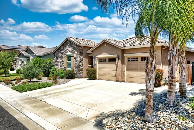 an aerial view of a houses with a city view
