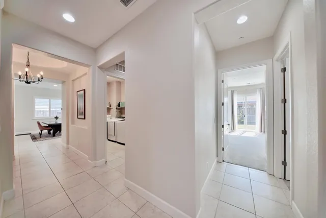 a spacious bathroom with a tub sink and mirror