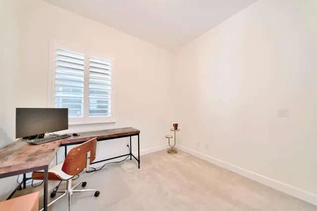 a bedroom with a bed and a large mirror