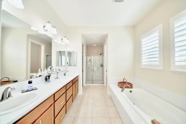 a view of a patio with couches table and chairs with potted plants