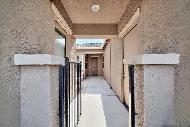 a kitchen with stainless steel appliances granite countertop a stove top oven a sink a dining table and chairs