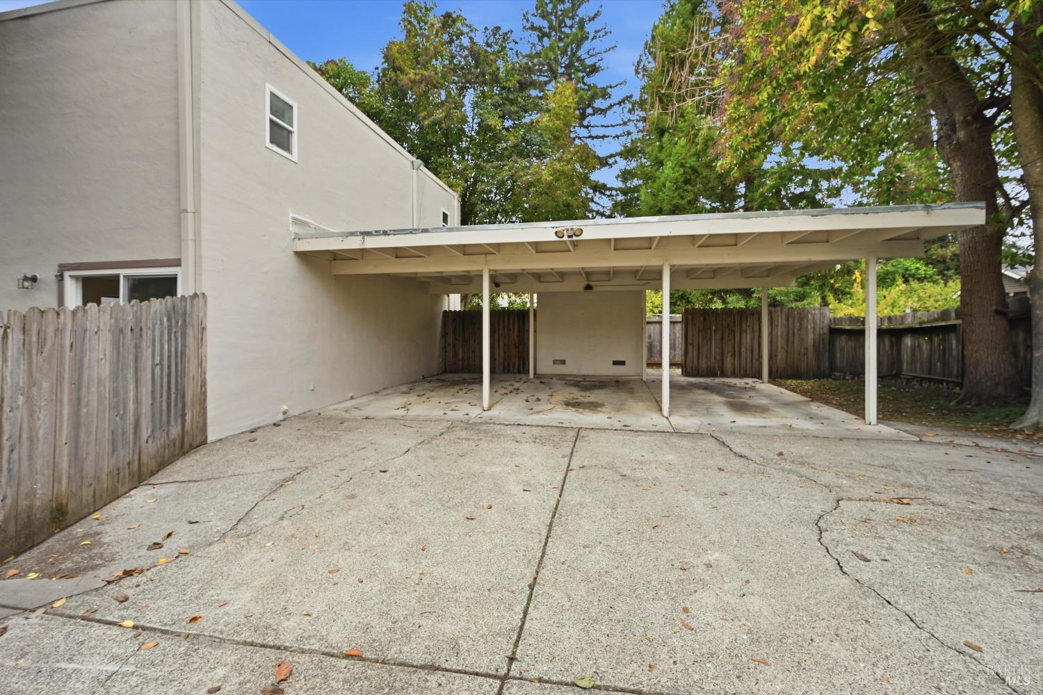 1213 Fair Oaks Avenue Santa Rosa, CA 95404 - Photo 21 of 27 a view of a patio with table and chairs with wooden floor and fence