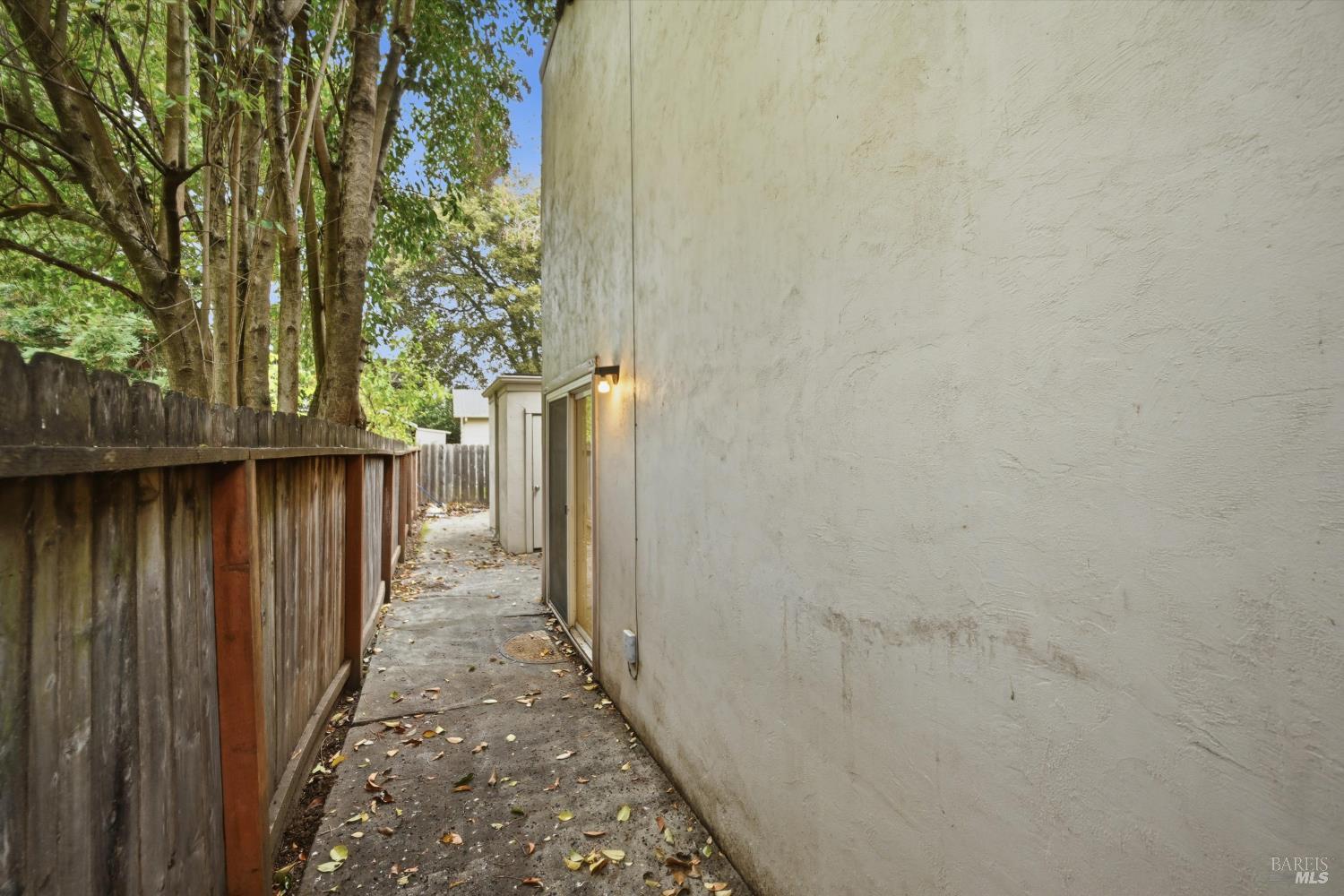 1213 Fair Oaks Avenue Santa Rosa, CA 95404 - Photo 25 of 27 a view of a pathway of a building with wooden fence