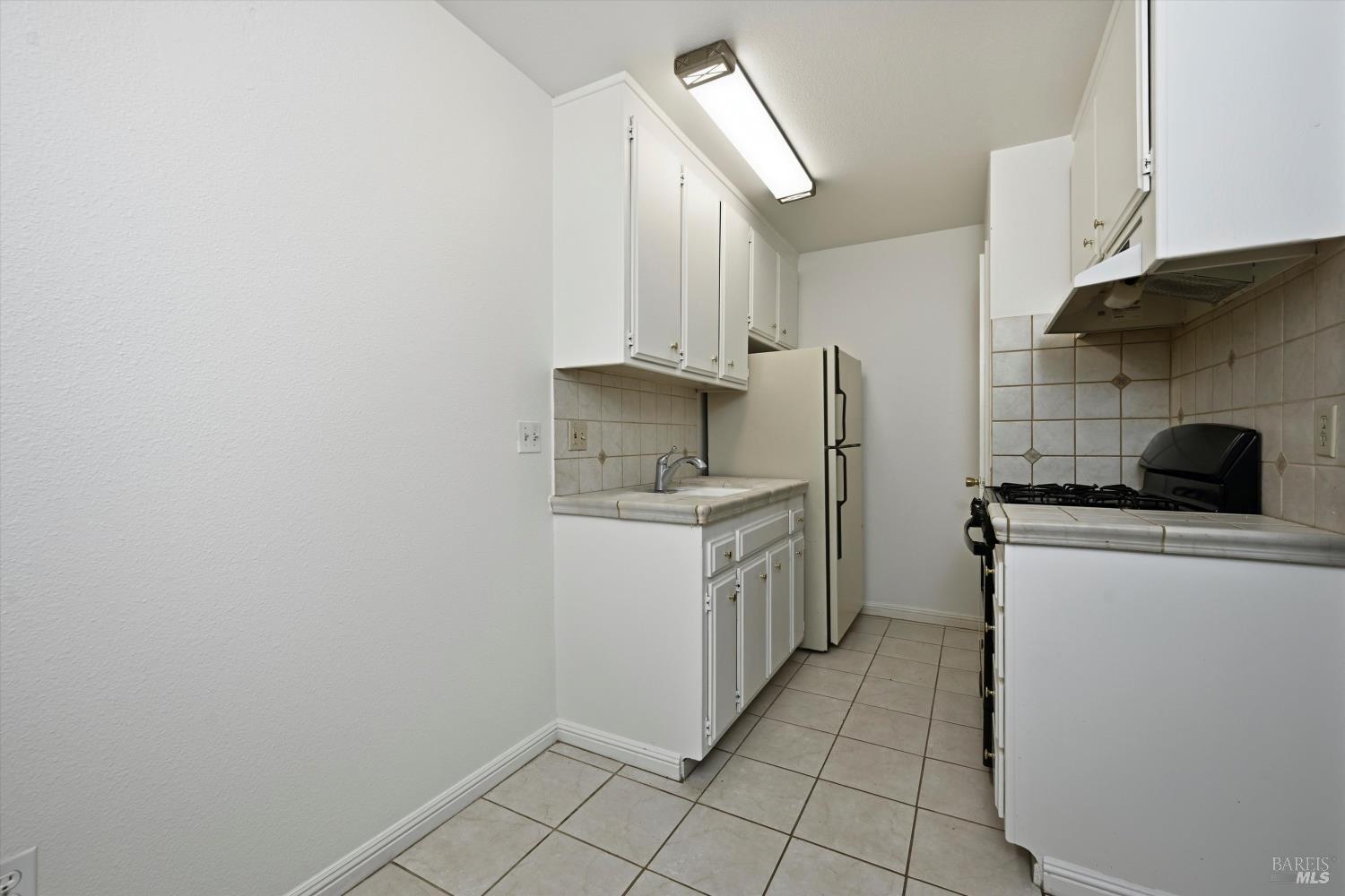 1213 Fair Oaks Avenue Santa Rosa, CA 95404 - Photo 5 of 27 a kitchen with a sink cabinets and appliances
