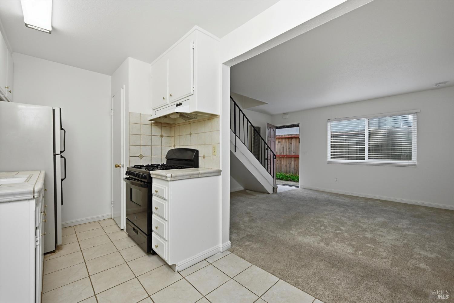 1213 Fair Oaks Avenue Santa Rosa, CA 95404 - Photo 6 of 27 a kitchen with a refrigerator and a stove top oven