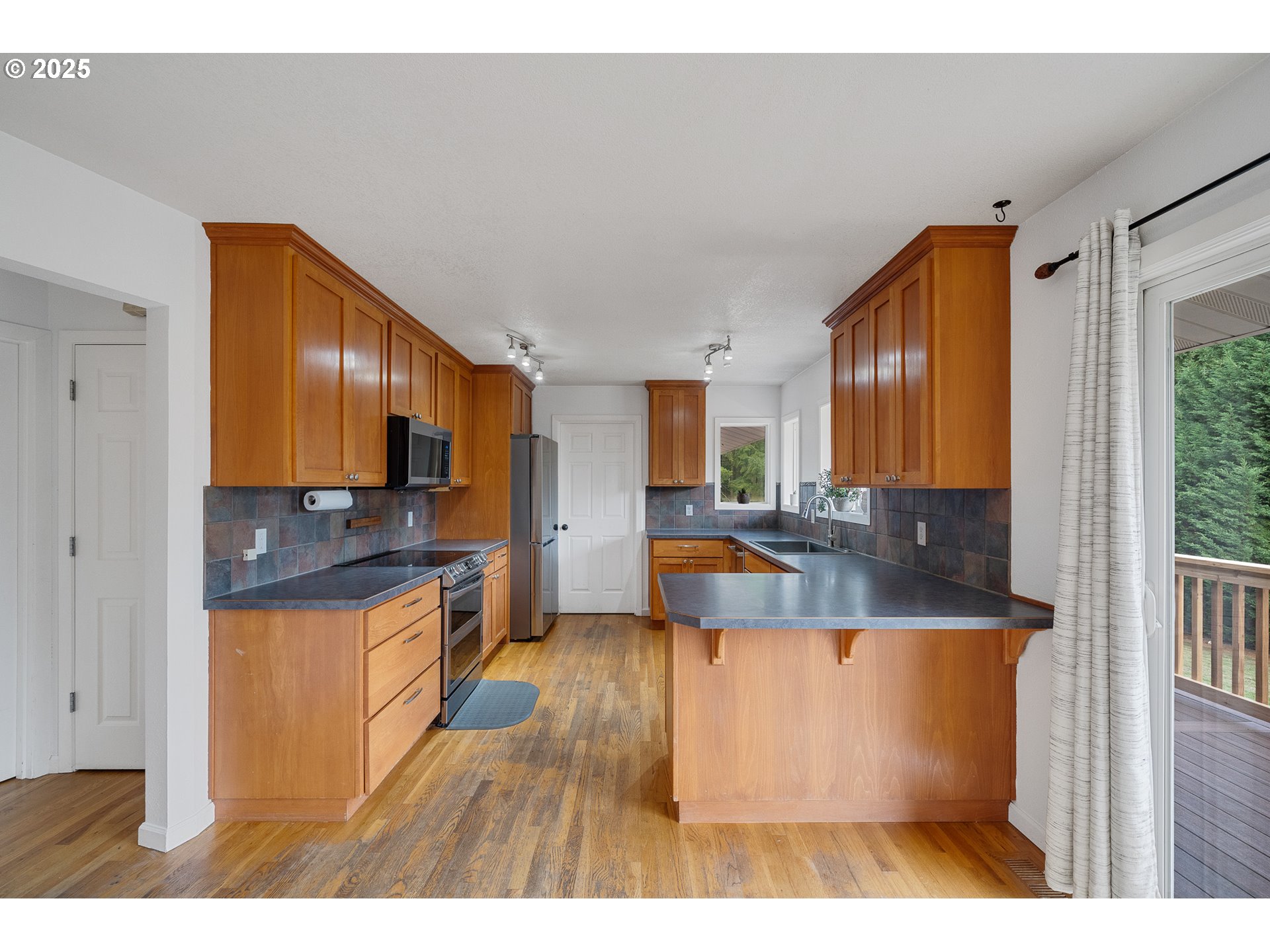 33281 Kammeyer Road Scappoose, OR 97056 - Photo 12 of 48 a large kitchen with stainless steel appliances granite countertop a granite counter tops and a view of living room