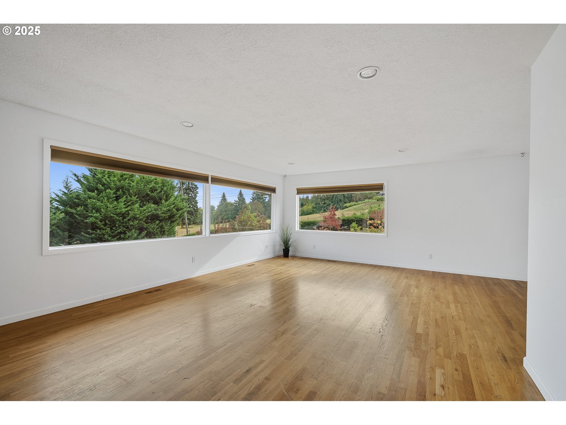 33281 Kammeyer Road Scappoose, OR 97056 - Photo 7 of 48 a view of an empty room with wooden floor and windows