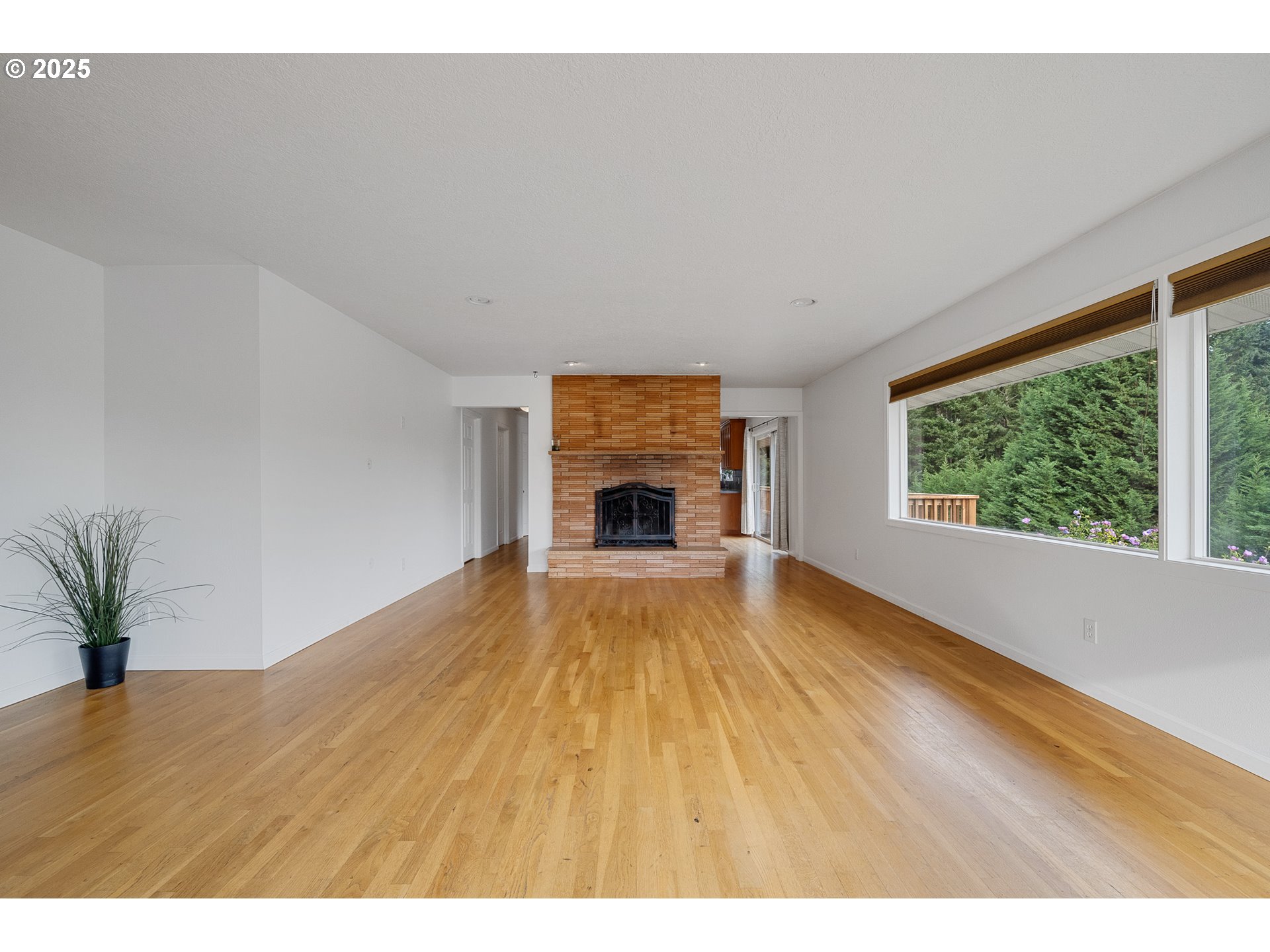 33281 Kammeyer Road Scappoose, OR 97056 - Photo 8 of 48 a view of empty room with wooden floor and fireplace