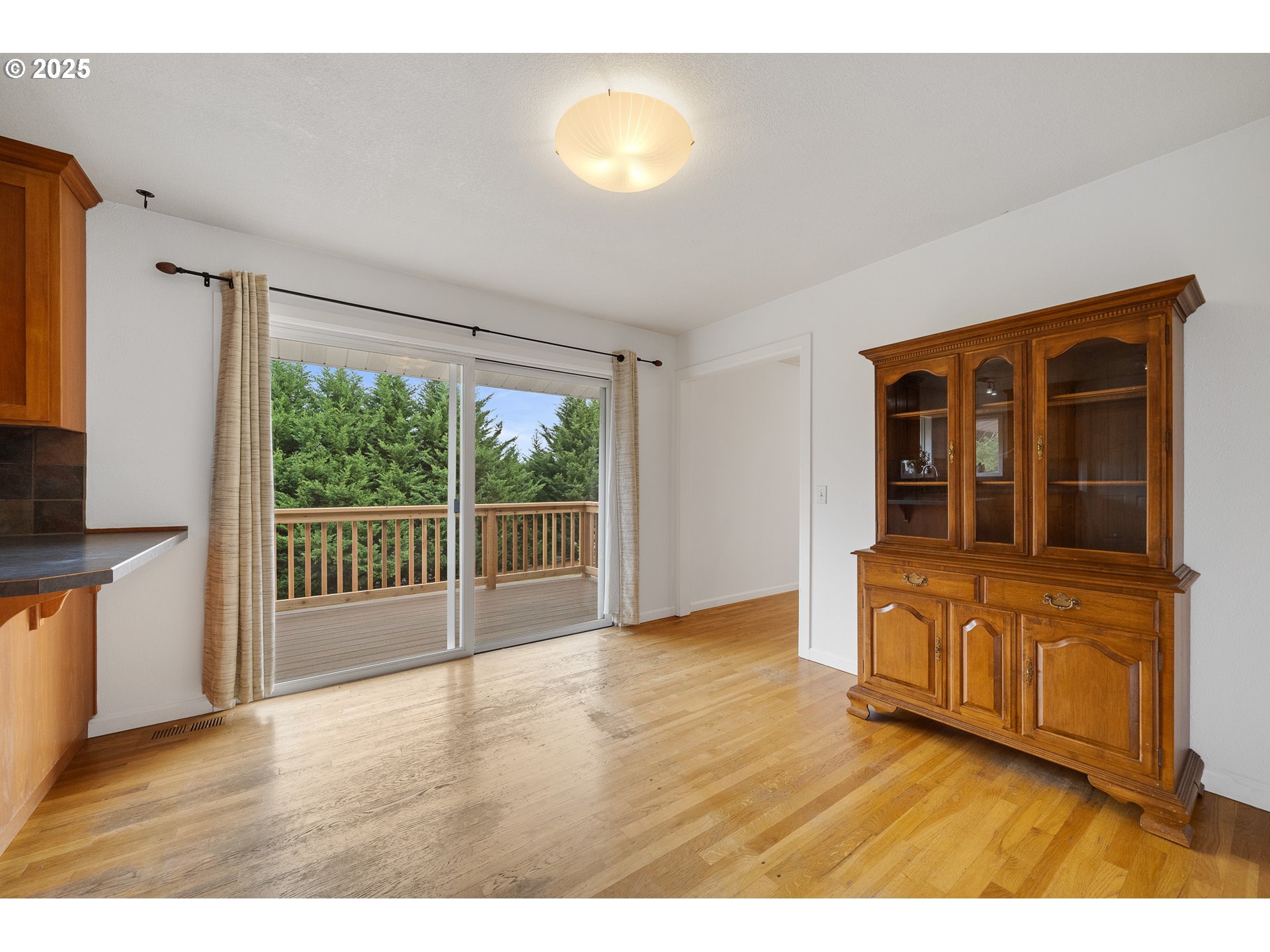 33281 Kammeyer Road Scappoose, OR 97056 - Photo 10 of 48 a view of an empty room with wooden floor and a window