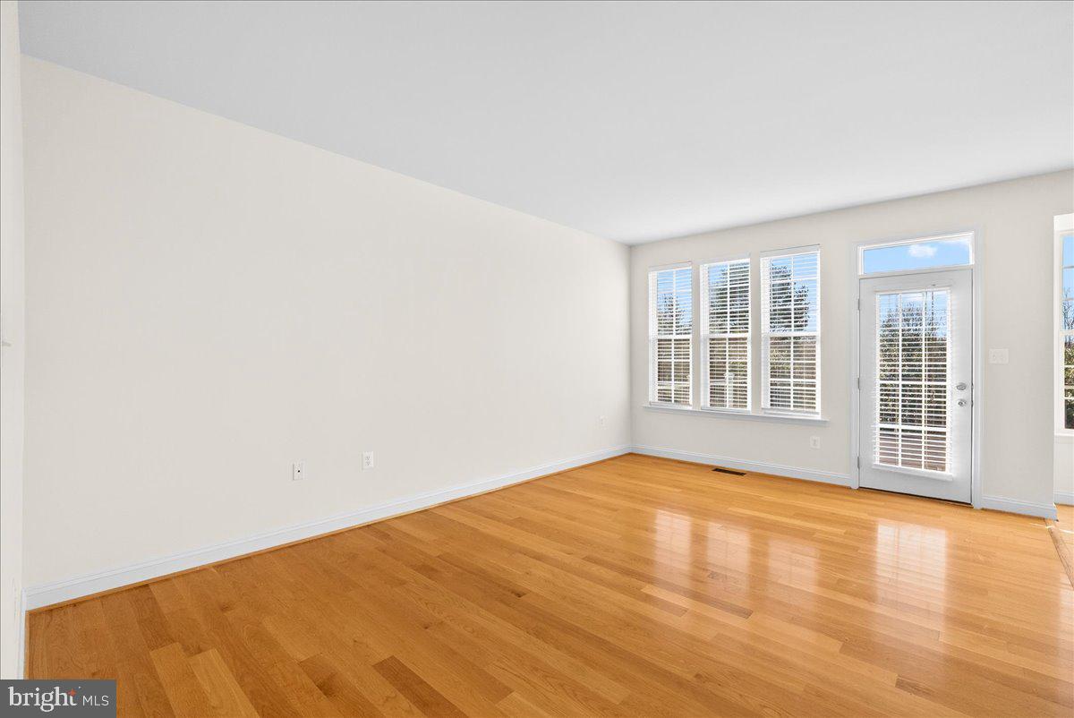 927 Buttonwood Terrace Northeast Leesburg, VA 20176 - Photo 11 of 44 a view of empty room with wooden floor and fan