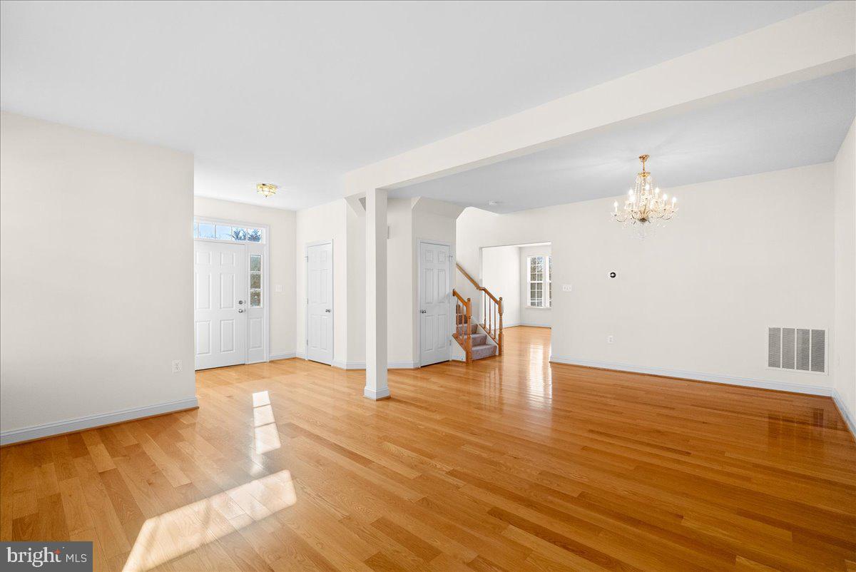 927 Buttonwood Terrace Northeast Leesburg, VA 20176 - Photo 4 of 44 a view of an empty room with wooden floor