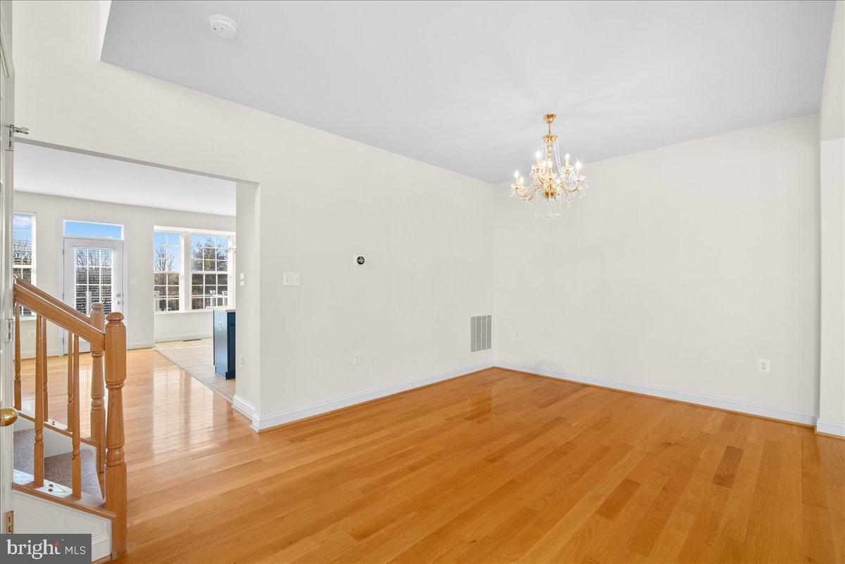 927 Buttonwood Terrace Northeast Leesburg, VA 20176 - Photo 7 of 44 wooden floor in an empty room with a window