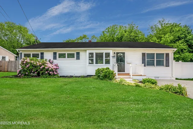 a front view of house with yard and green space