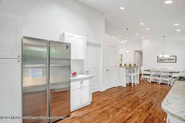 a living room with kitchen island furniture and a fireplace