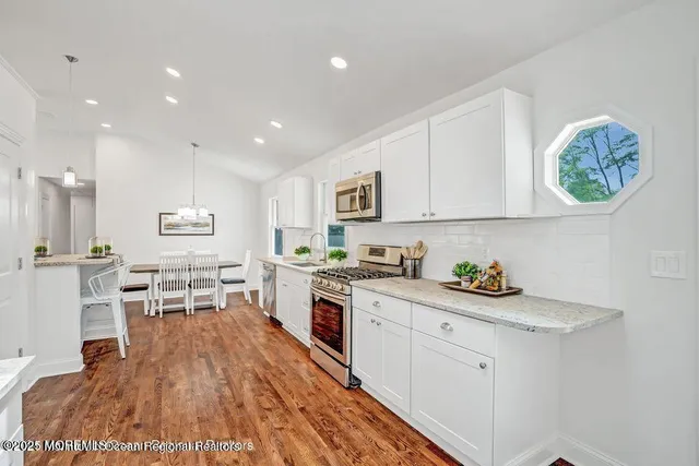 a living room with granite countertop furniture a fireplace and a potted plant