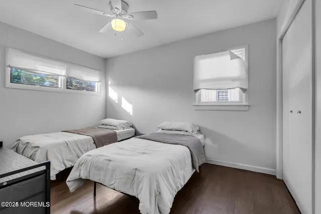a bedroom with two beds and a chandelier