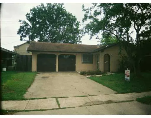a front view of a house with a garden and yard