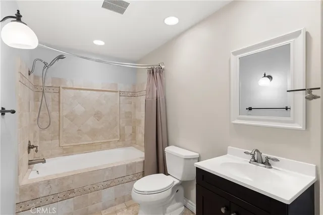 a bathroom with a sink toilet tub and shower