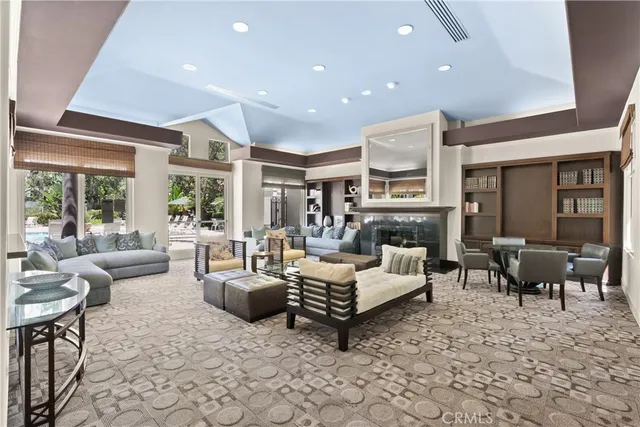 a living room with fireplace furniture and a large window