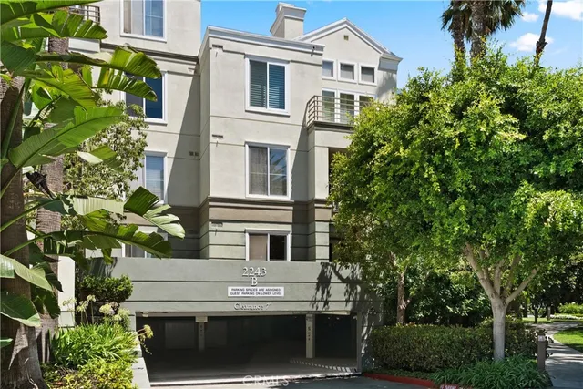 a front view of a building with a garden