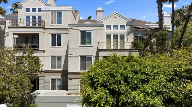a view of a white building among the top of house