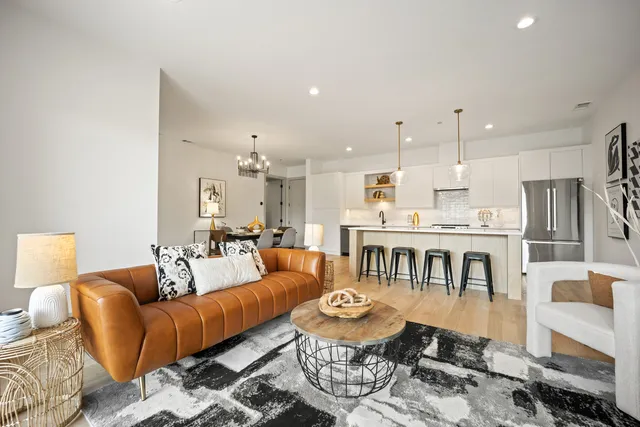 a living room with furniture and kitchen view