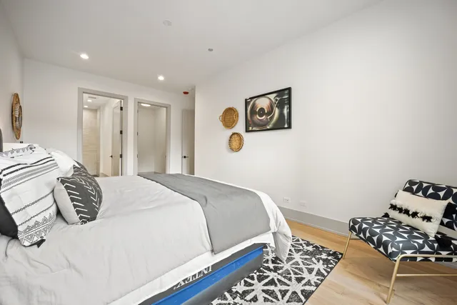 a bedroom with a bed and wooden floor