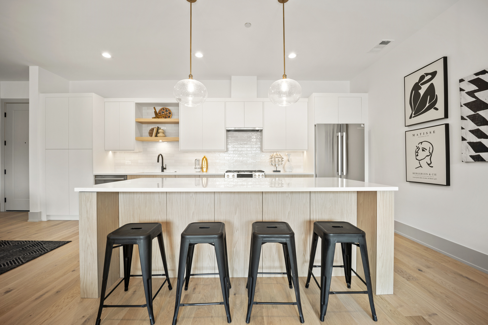 1548 West Ardmore Avenue, Unit 3B Chicago, IL 60660 - Photo 8 of 32 a kitchen with stainless steel appliances granite countertop a kitchen island and chairs in it