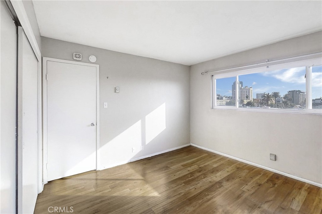 545 Chestnut Avenue, Unit 406 Long Beach, CA 90802 - Photo 11 of 16 a view of empty room with wooden floor