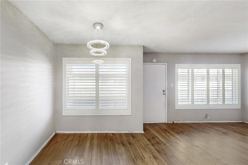 545 Chestnut Avenue, Unit 406 Long Beach, CA 90802 - Photo 8 of 16 an empty room with wooden floor and windows